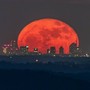 La foto della Luna rossa che attraversa lo skyline di Milano è nata sulle alture del lago Maggiore